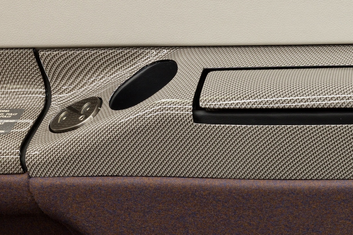 The armrest from the interior of a Pilatus PC-12, which features a light-coloured, carbon fibre motif applied using a hydrodipping process.